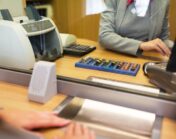 clerk counting cash money at bank office