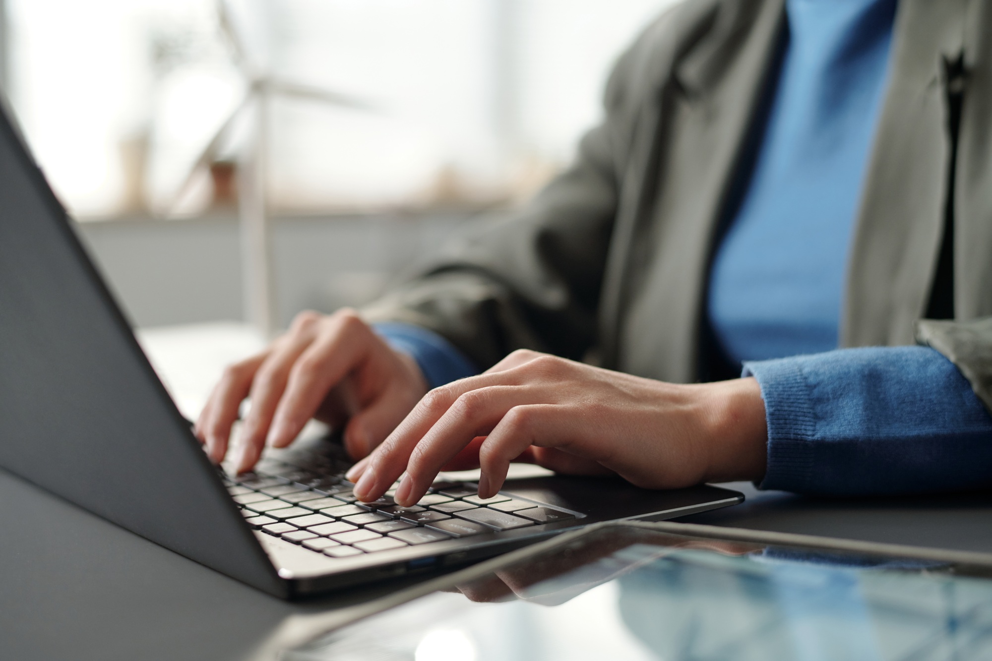 Manager touching keys of laptop keyboard